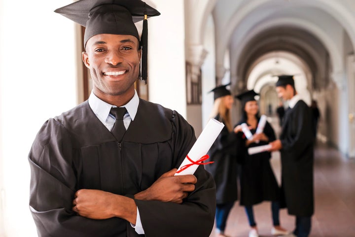 college graduate holding his diploma | Flow Subaru Burlington in Burlington NC