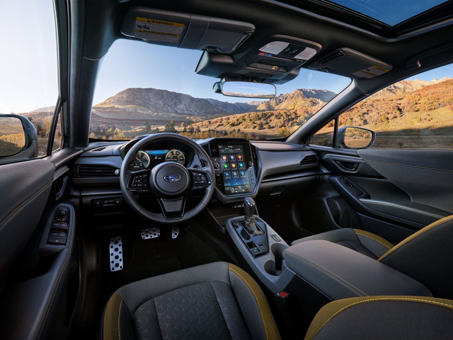 Interior of the new Subaru Crosstrek Hybrid, including the front dash and a view of the mountains out of the front window
