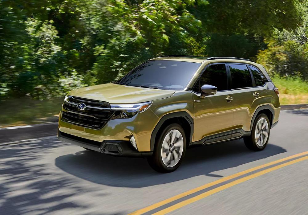 Green Subaru Forester Hybrid driving down a paved road