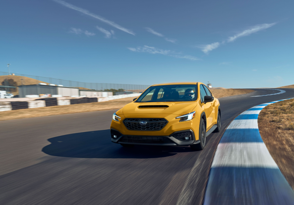 Yellow Subaru WRX driving towards the camera